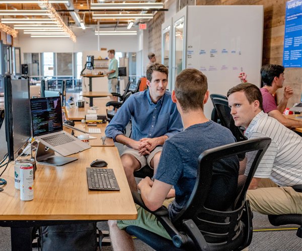 Creative professionals discussing a digital project in a studio